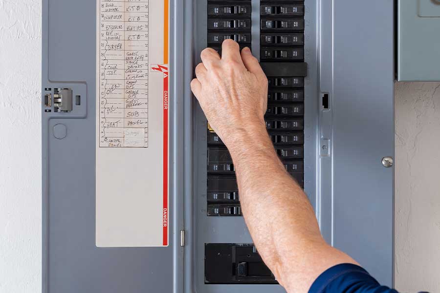 Technician inspecting electrical panel