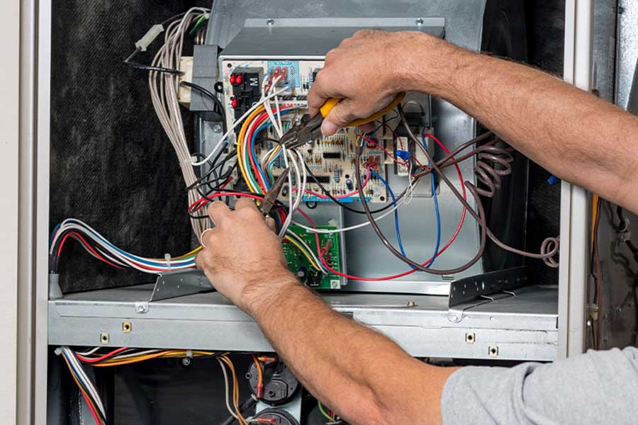 Technician repairing furnace